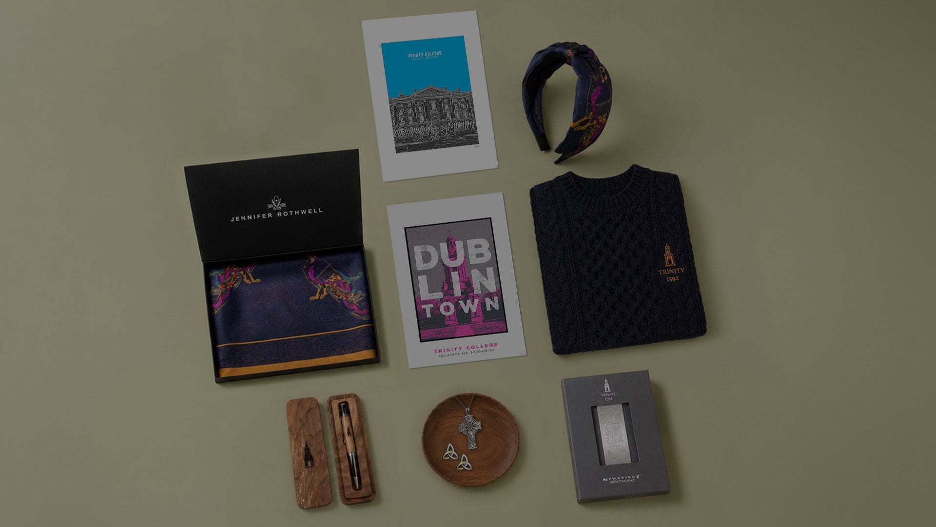 Collection of items including a book, headband, and small objects on a beige background