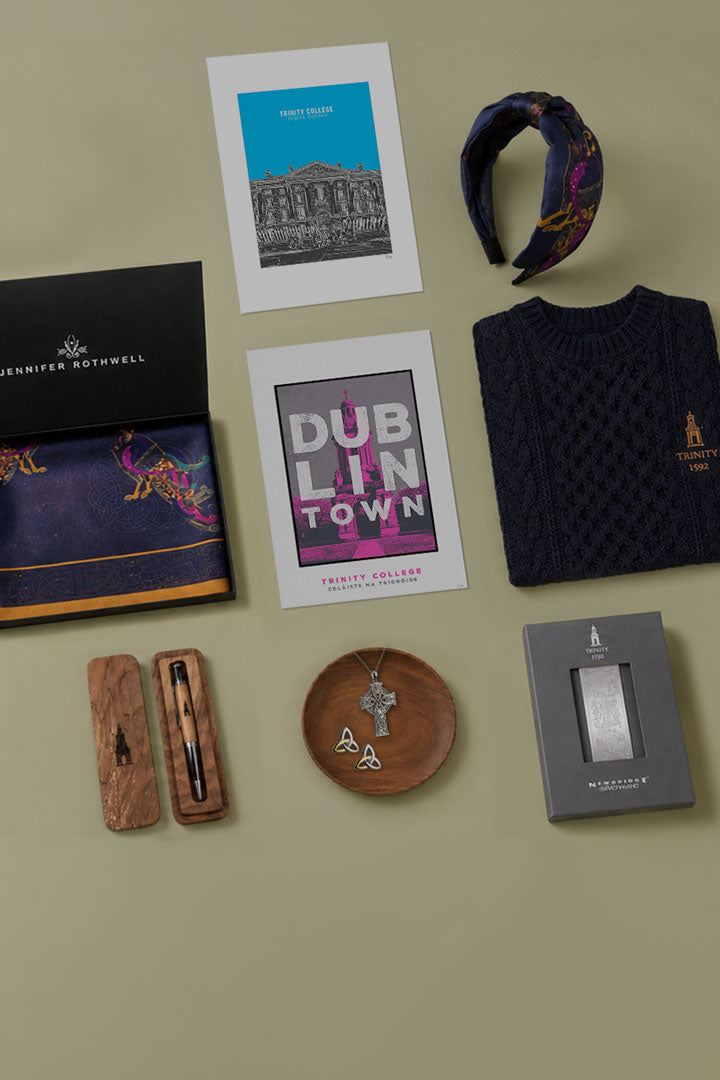 Collection of items including a sweater, headband, and decorative objects on a green surface